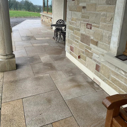 Small patio area completed using Bush Hammered Gold Granite Paving in mixed sizes.  