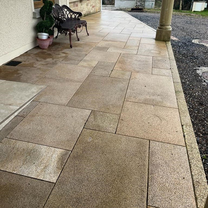 Small patio area completed using Gold Granite Paving in mixed sizes.  