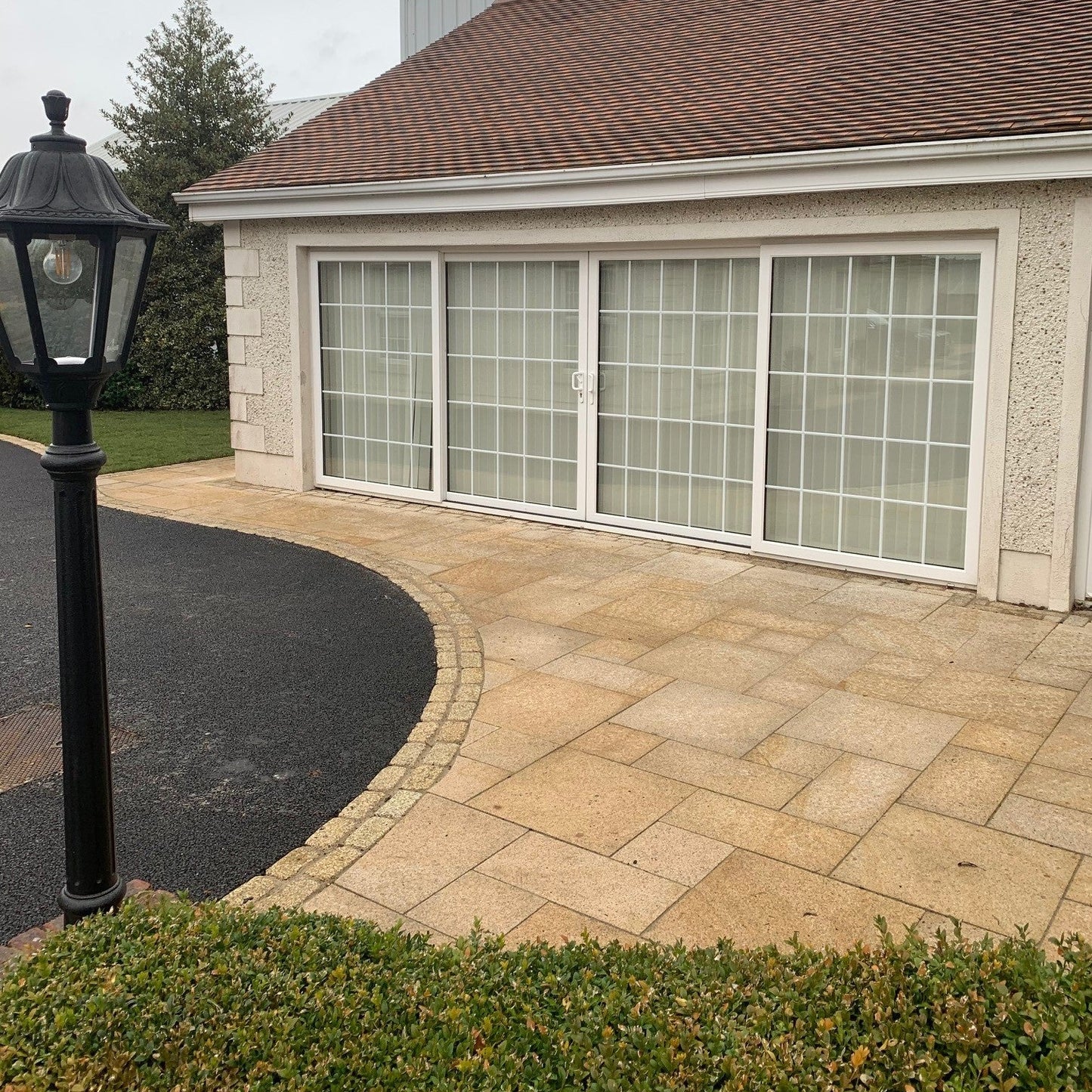 Patio area bordering a driveway. Paving is Gold Granite in mixed patio sizes. 