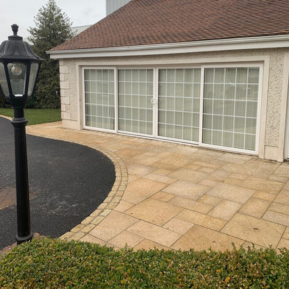 Patio area bordering a driveway. Paving is Gold Granite in mixed patio sizes. 