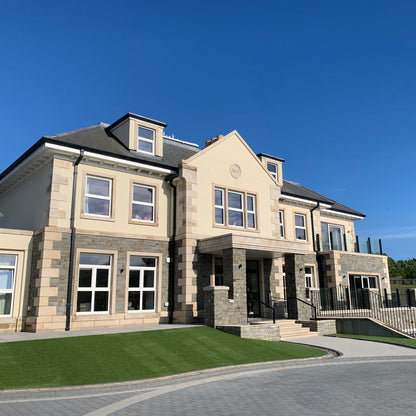 Large stone house with bespoke Gold Granite Quoins, Plinth, Steps and window surrounds. 
