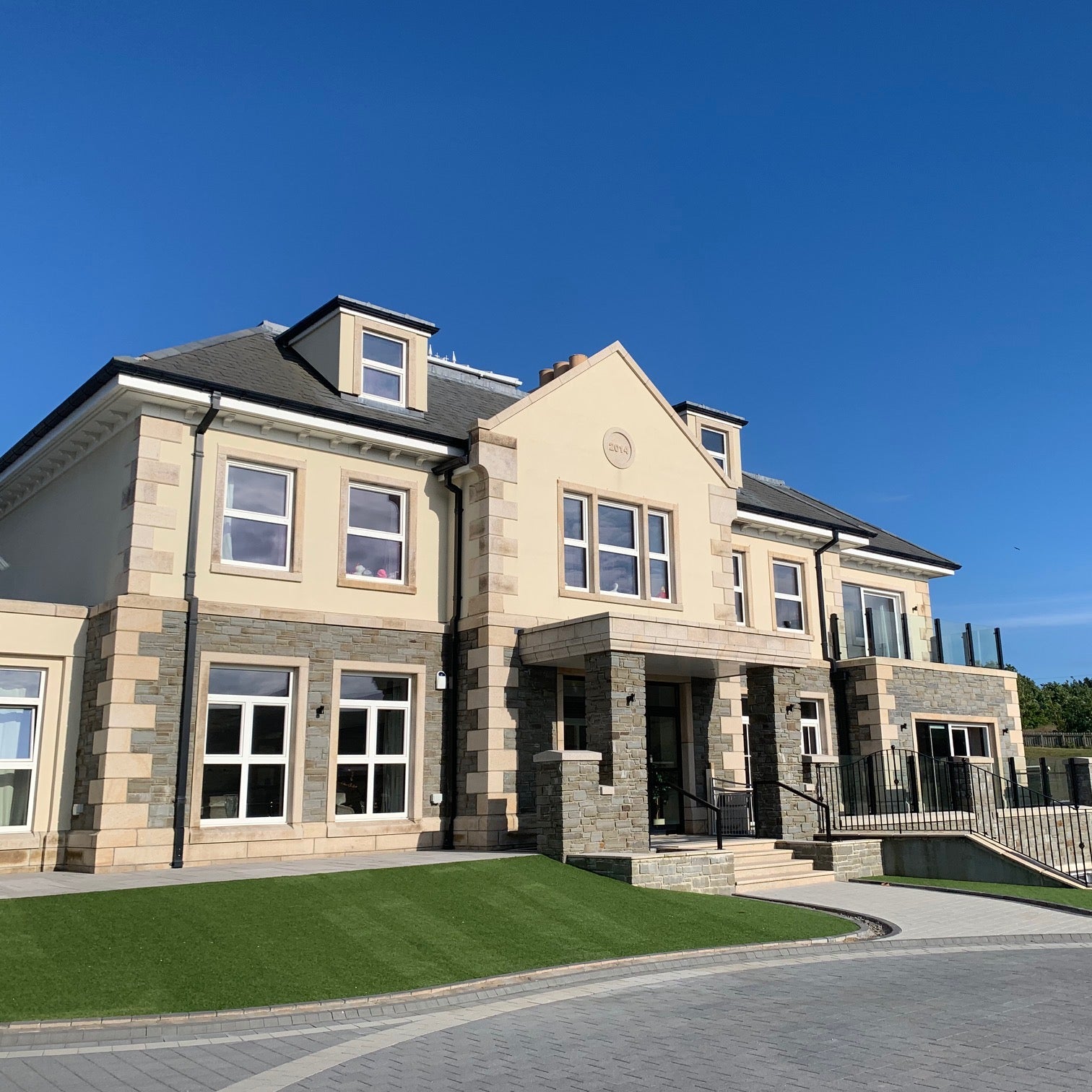 Large stone house with bespoke Gold Granite Quoins, Plinth, Steps and window surrounds. 