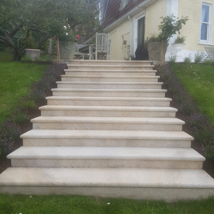 Set of Gold Granite Steps & Riser Sets leading up to a house with a garden