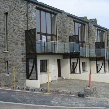 Modern stone apartment building with balconies on a clear day