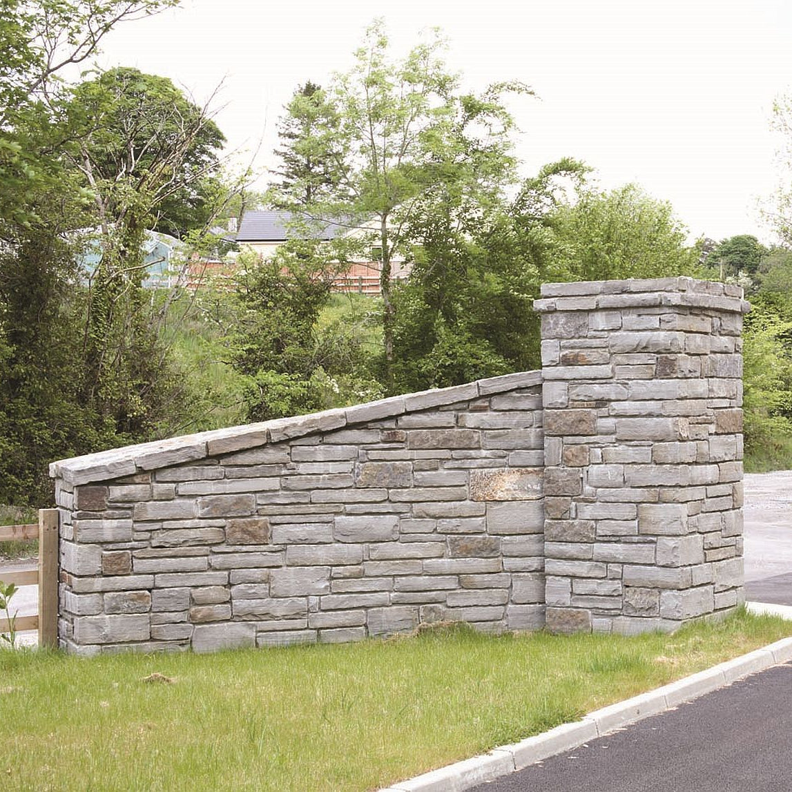 Stone wall in Grey Sandstone Machined walling stone with a natural landscape background