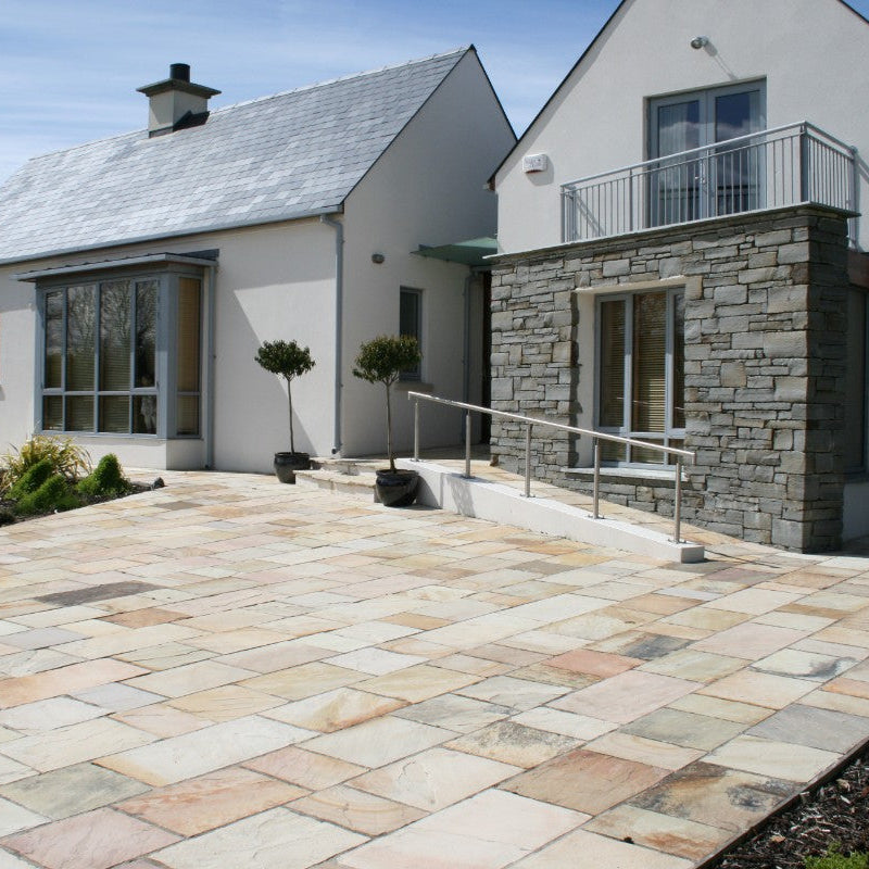 Modern house with stone feature wall in grey sandstone machined walling.