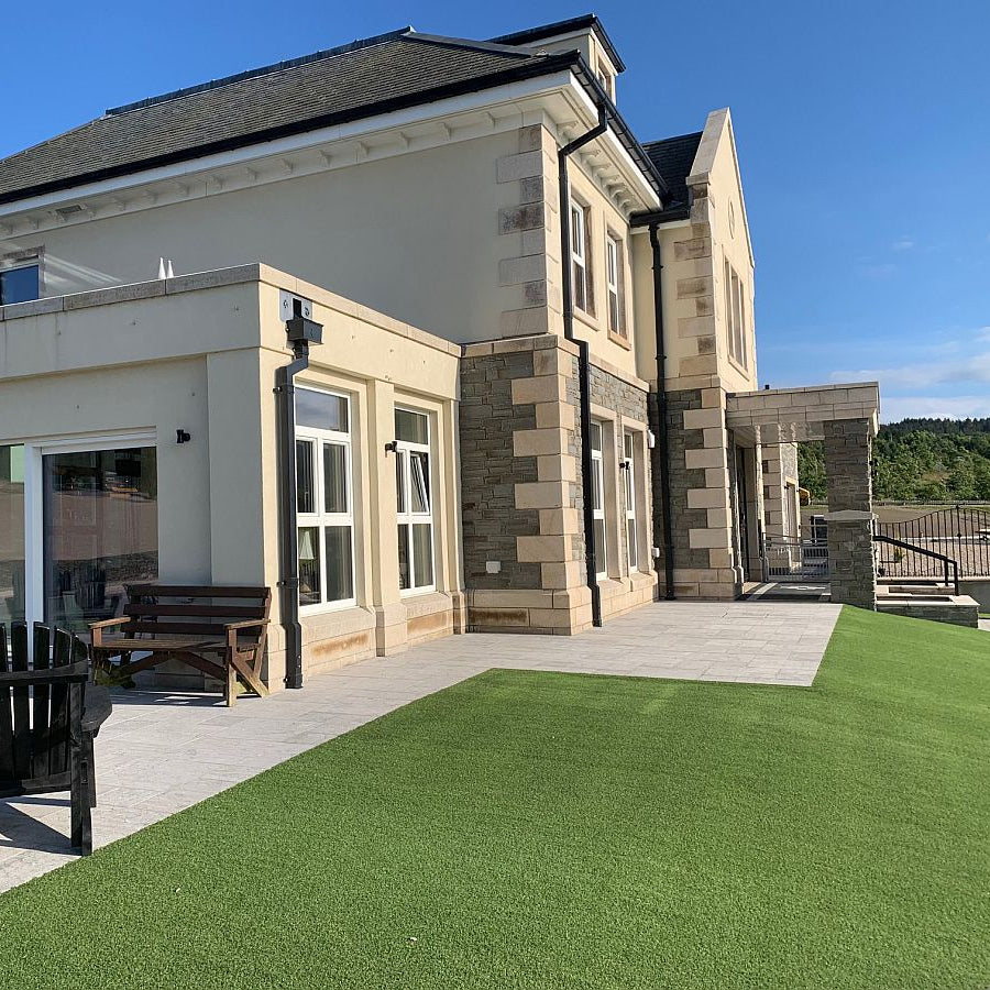 Different angle of the same two storey house with grey sandstone machined walling stone. 