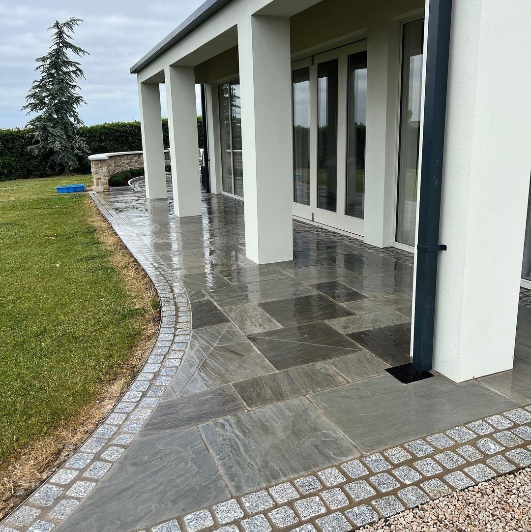 Modern pathway completed in Grey Sandstone Paving. 