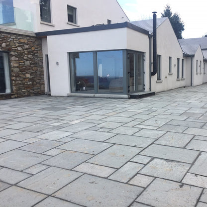 Large modern house with patio area completed using Grey Sandstone Patio Packs. 