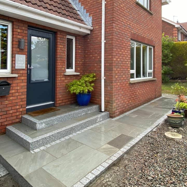 Red brick house with two entrance steps and pathway featuring Grey Sandstone Paving, Silver Granite Cobbles and Step Risers. 
