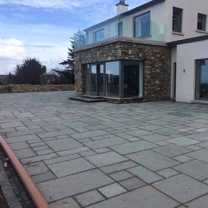 Large patio area featuring Grey Sandstone Paving. 