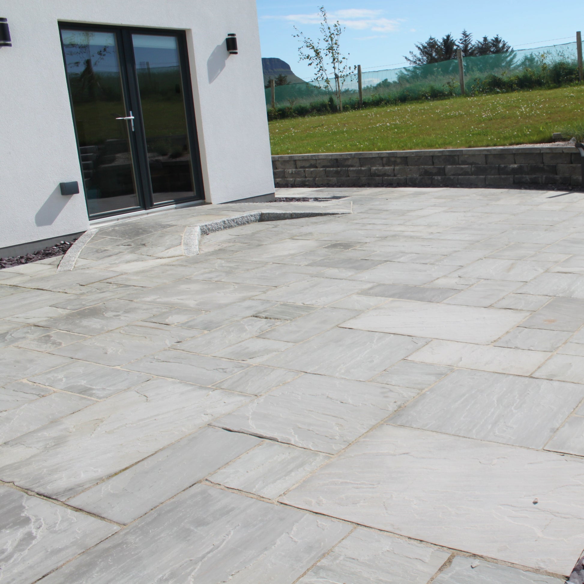 Patio area and ramp finished in Grey Sandstone Paving. 