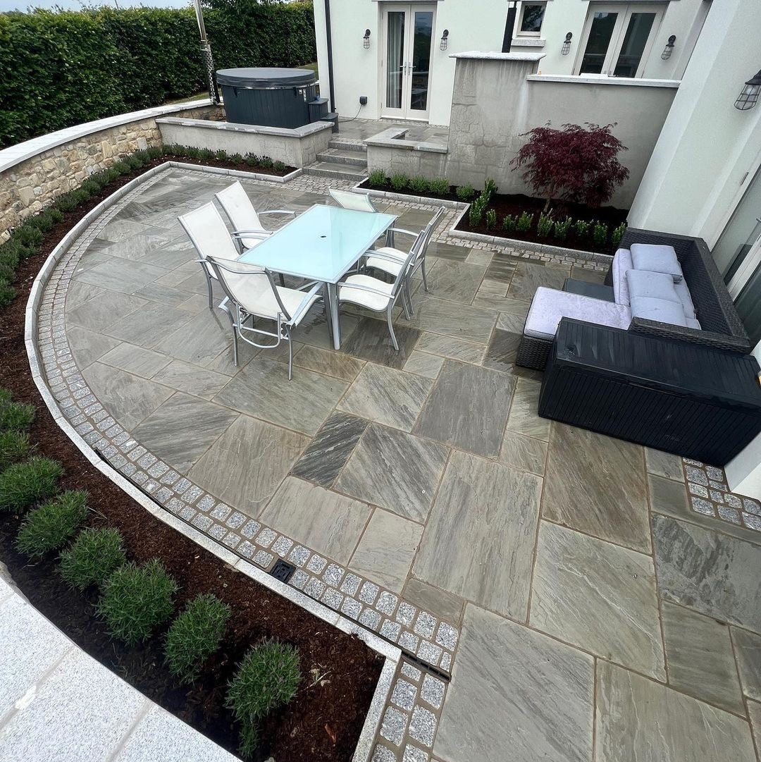 Curved patio area completed using Grey Sandstone Paving. 