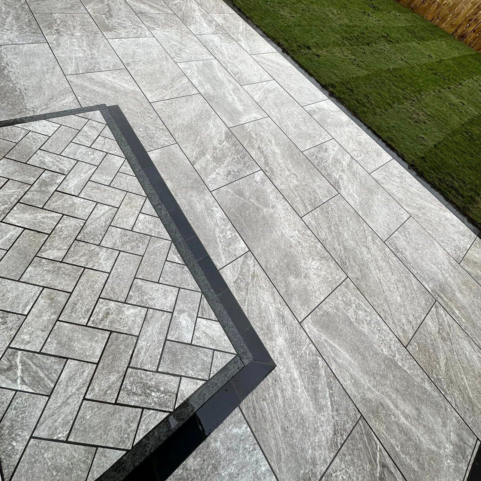 Close up of Grey Twice Qz Range Porcelain Paving Tiles with unique step design. 