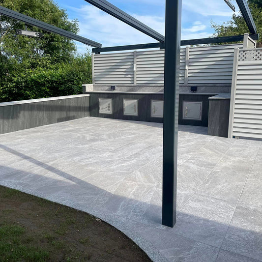 BBQ Patio area featuring Grey Twice Qz Range Porcelain Paving Tiles. 