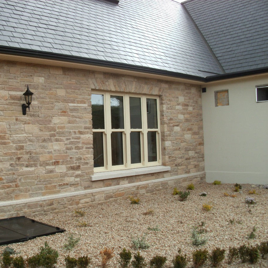 Close up of stone façade featuring Grit Sandstone Machined.