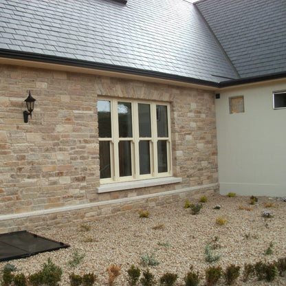 Close up of stone façade featuring Grit Sandstone Machined.