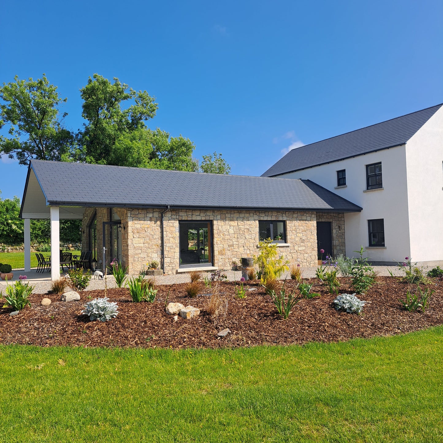 New build house with stone façade completed in Grit Sandstone Stoneer Cladding.