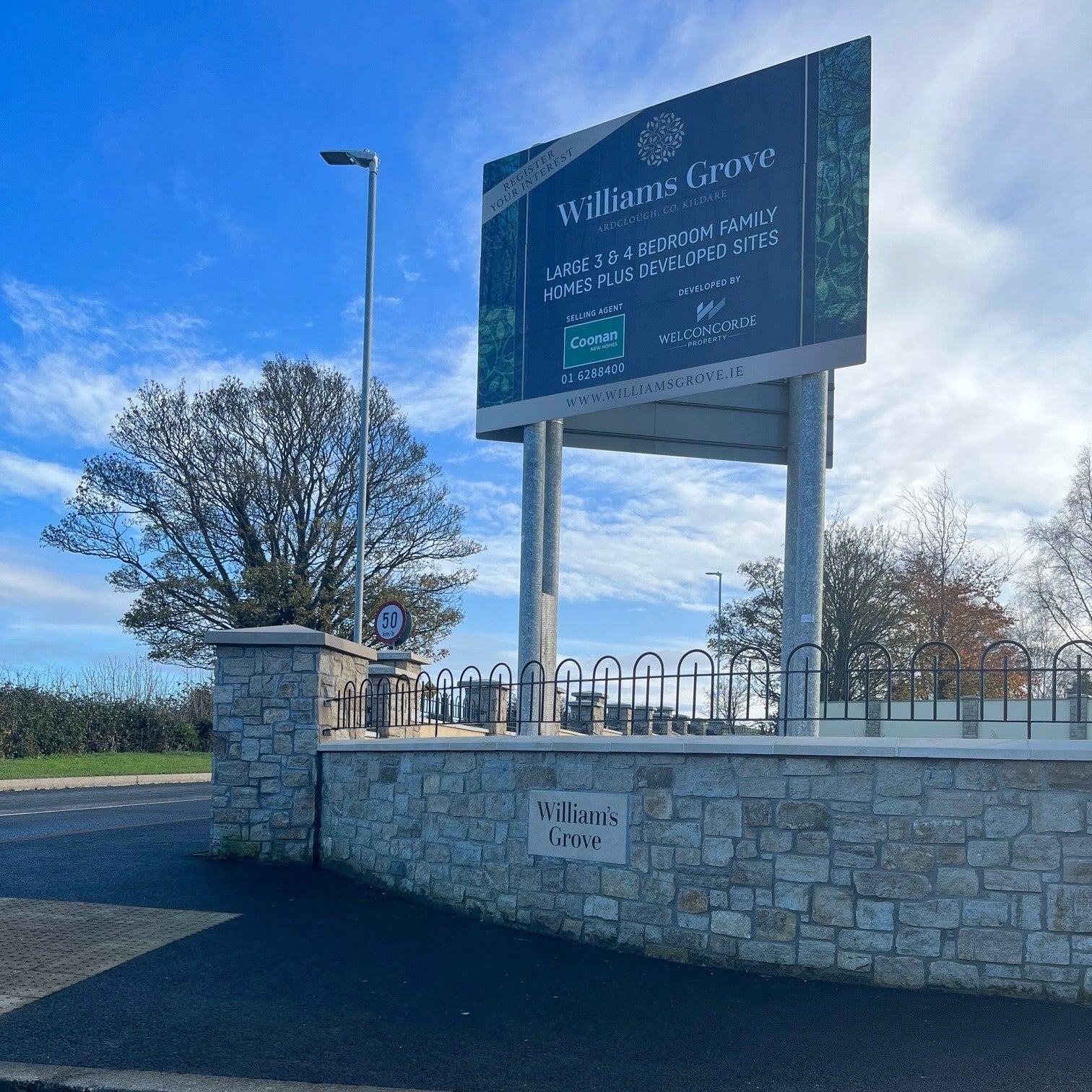 Estate boundary wall and pillar finished in Grit Sandstone Stoneer Cladding.