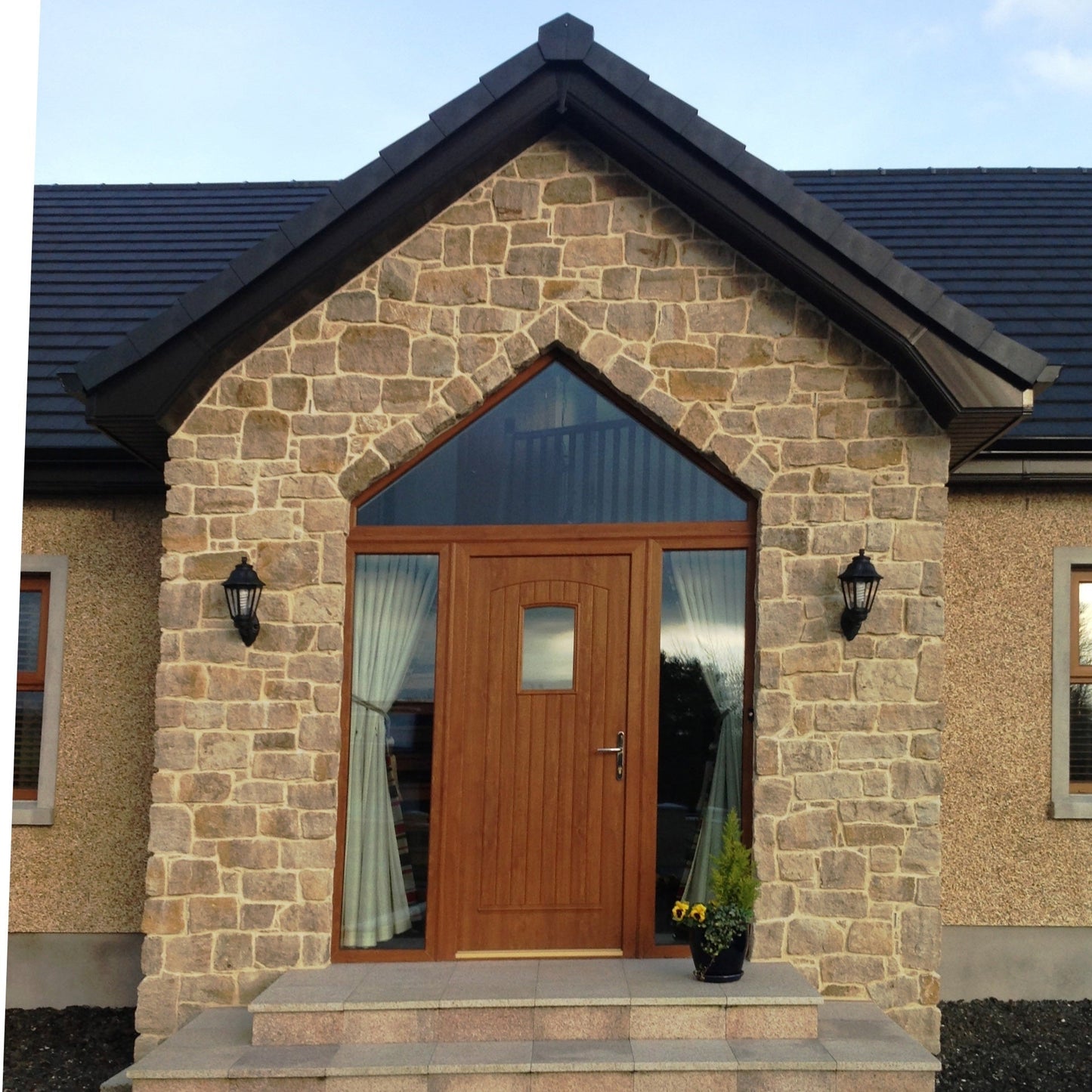 Entrance feature wall finished in Grit Sandstone Stoneer Cladding.