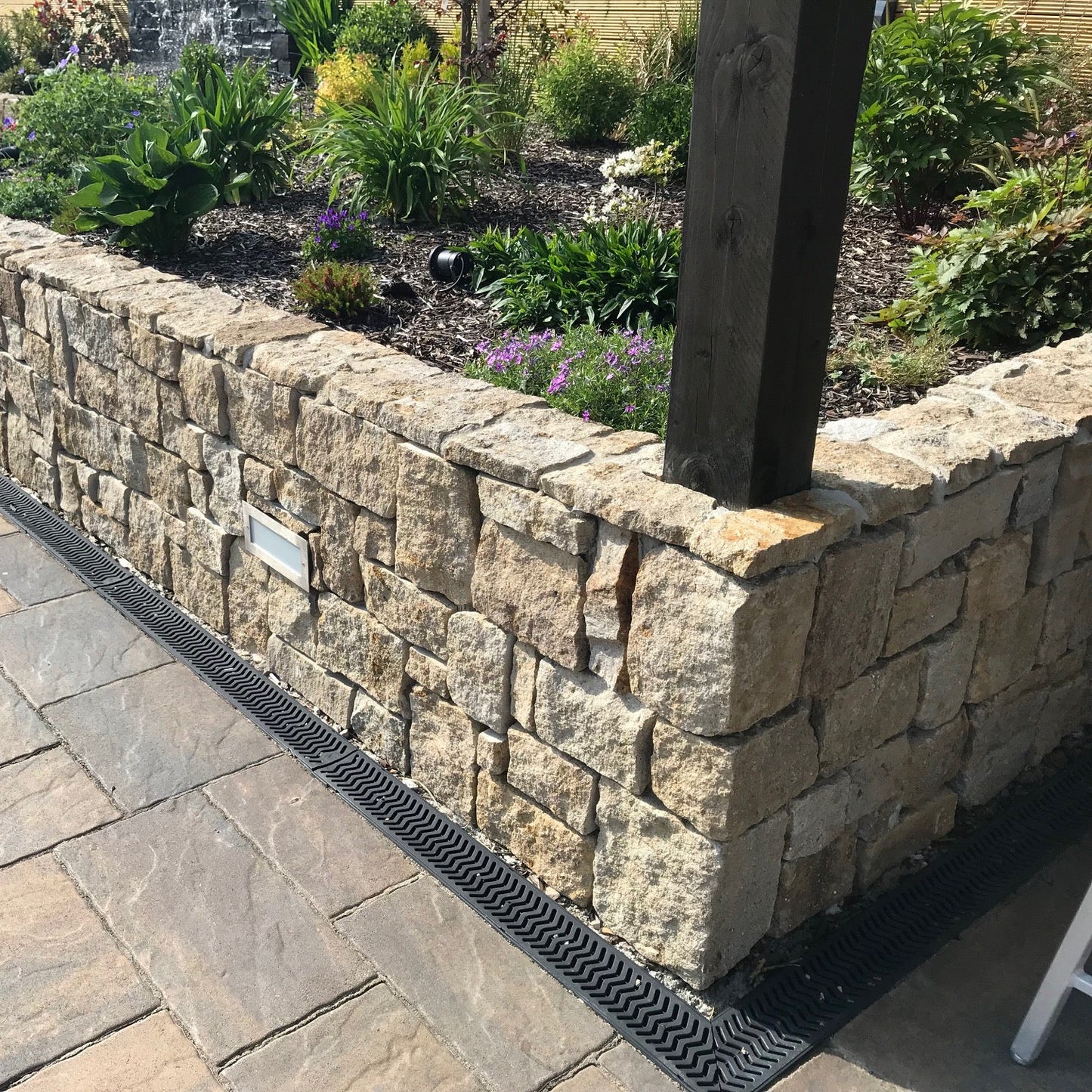 Hotel garden wall finished in Grit Sandstone Stoneer Cladding.