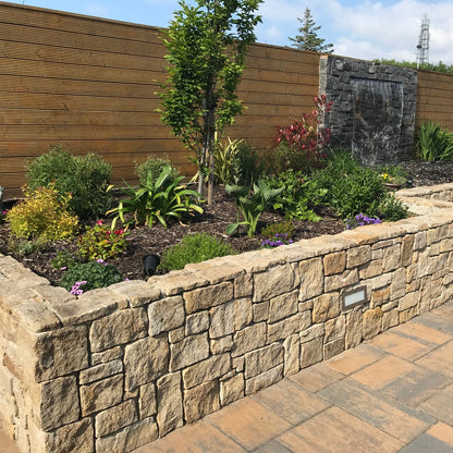 Hotel garden wall featuring Grit Sandstone Stoneer Cladding. 