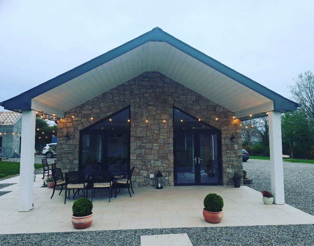 Patio area of a new build house with stone façade completed in Grit Sandstone Stoneer Cladding.