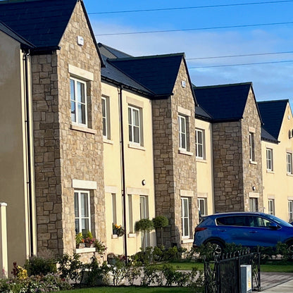 Estate housing with stone feature walls finished in Grit Sandstone Stoneer Cladding.