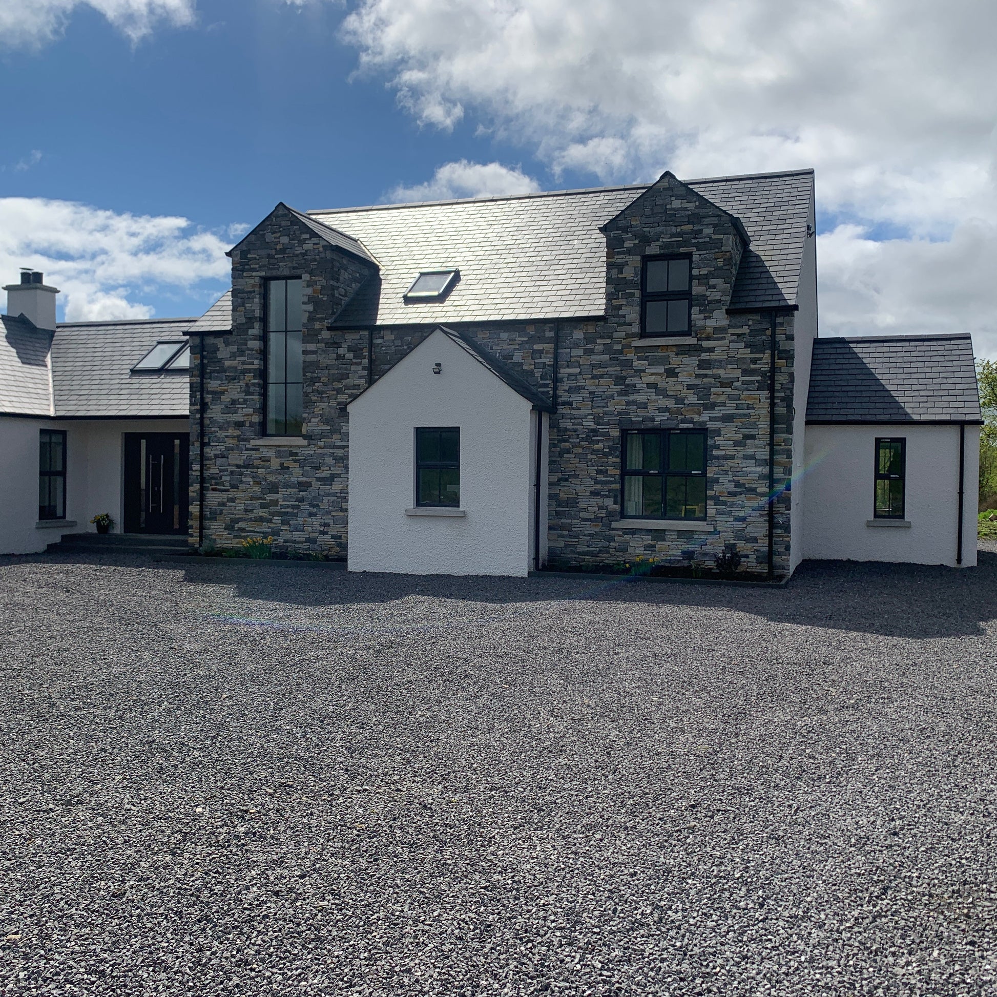 Modern new build completed using Highland Blend Tumbled with natural stone chipping in the foreground.