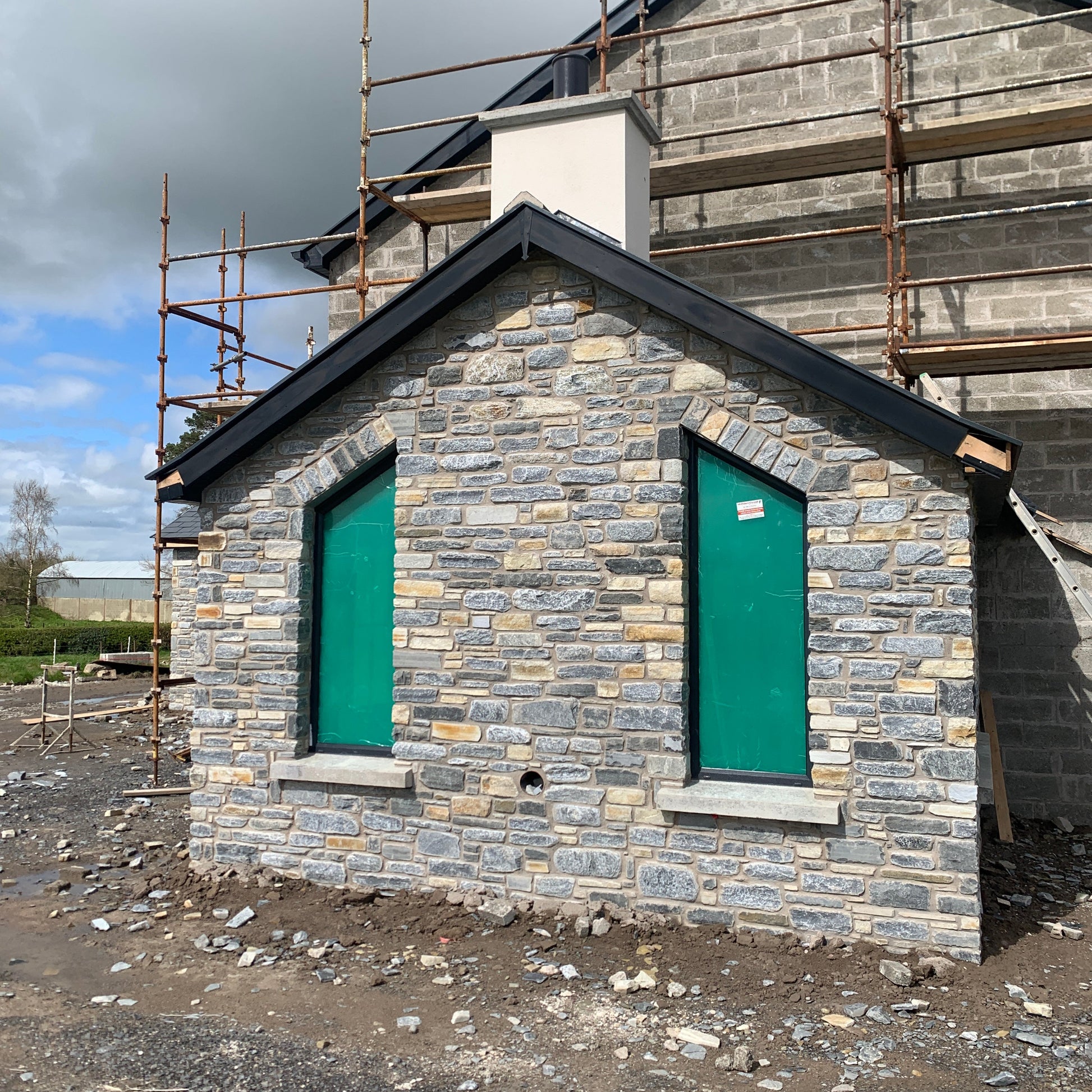 House under construction with stone outshot finished in Highland Blend Tumbled.