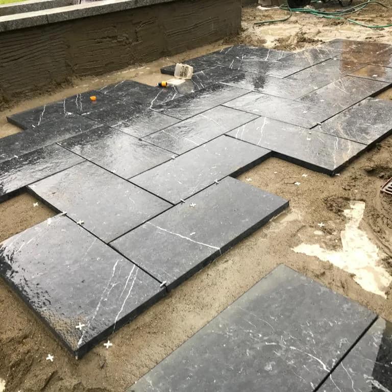Patio area under construction with Irish Blue Limestone Paving being installed. 