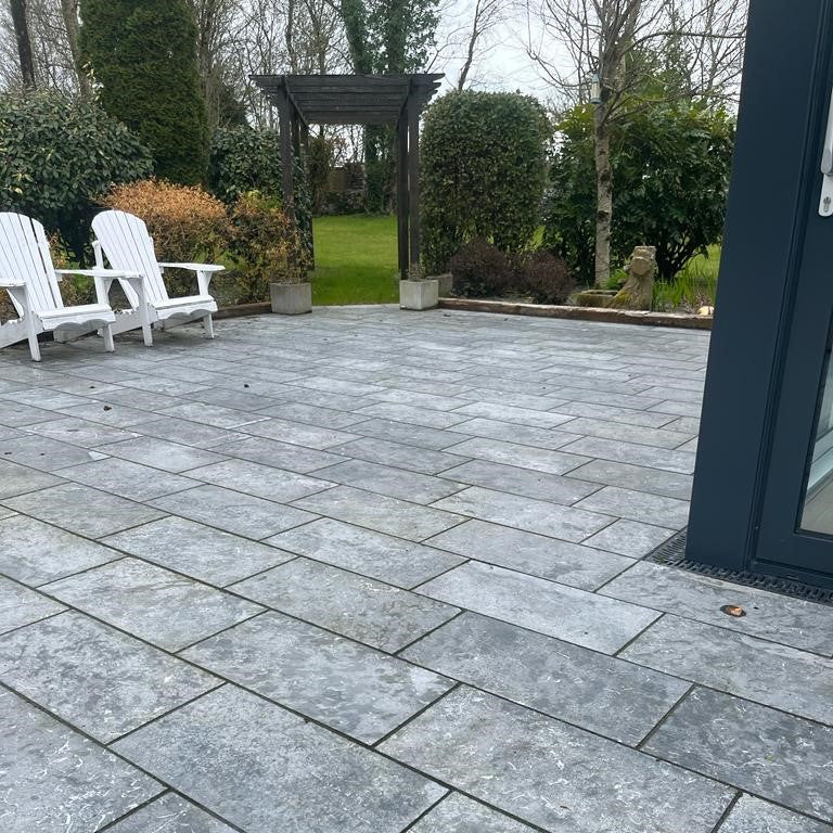 Patio area with wooden archway to garden. Paving is Irish Blue Limestone. 