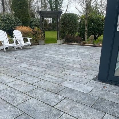 Patio area with wooden archway to garden. Paving is Irish Blue Limestone. 