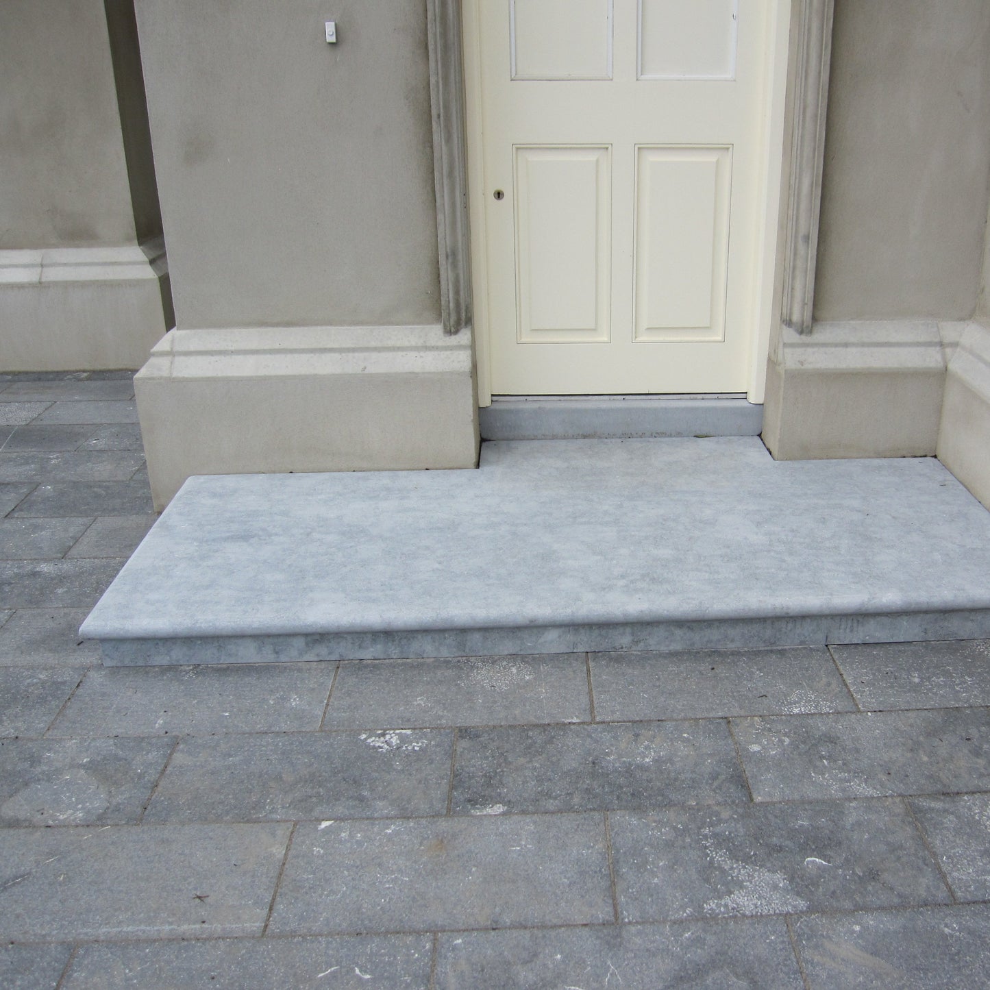 Irish Blue Limestone step in a sanded finish surrounded by Irish Blue Limestone Paving. 