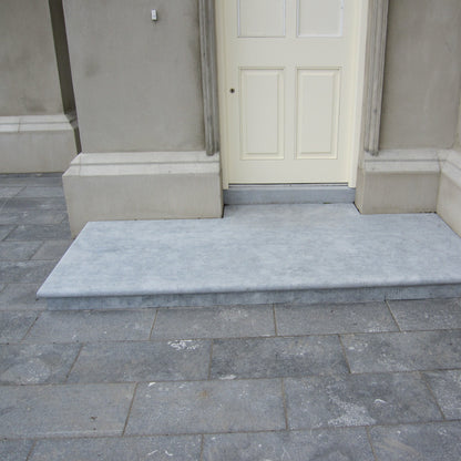 Irish Blue Limestone step in a sanded finish surrounded by Irish Blue Limestone Paving. 