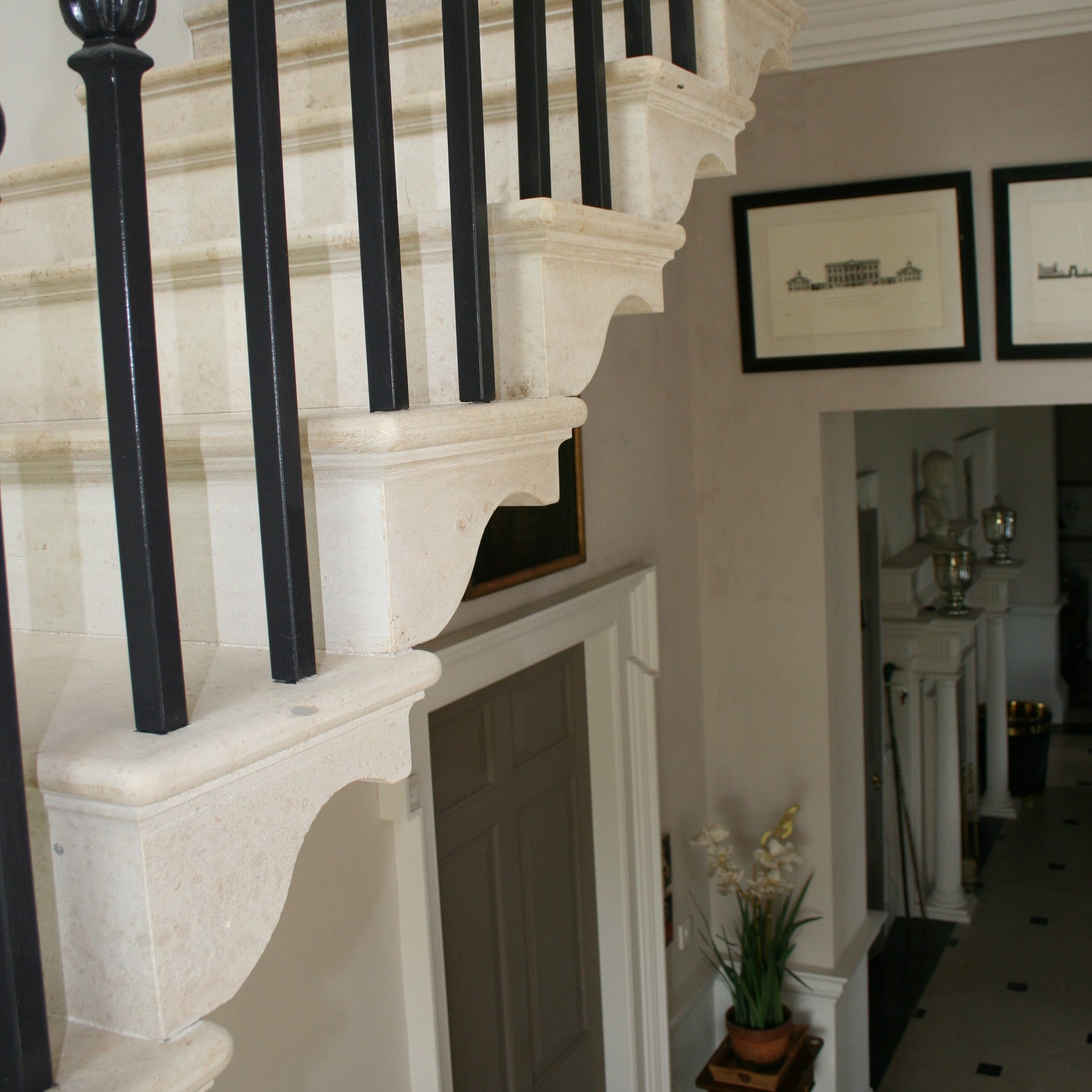 Bespoke Limestone Staircase with black balusters in a home interior.