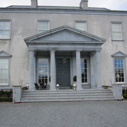Large grey mansion with bespoke Limestone Portico and steps leading to the entrance