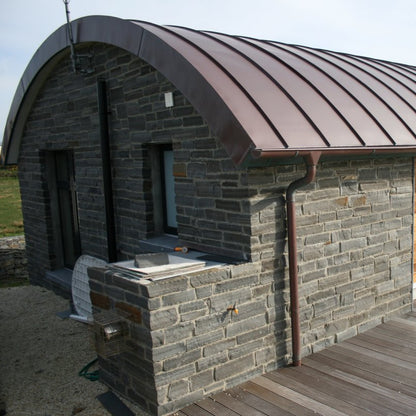 Modern home design with unique round roof and Liscannor Slate Building Stone. 