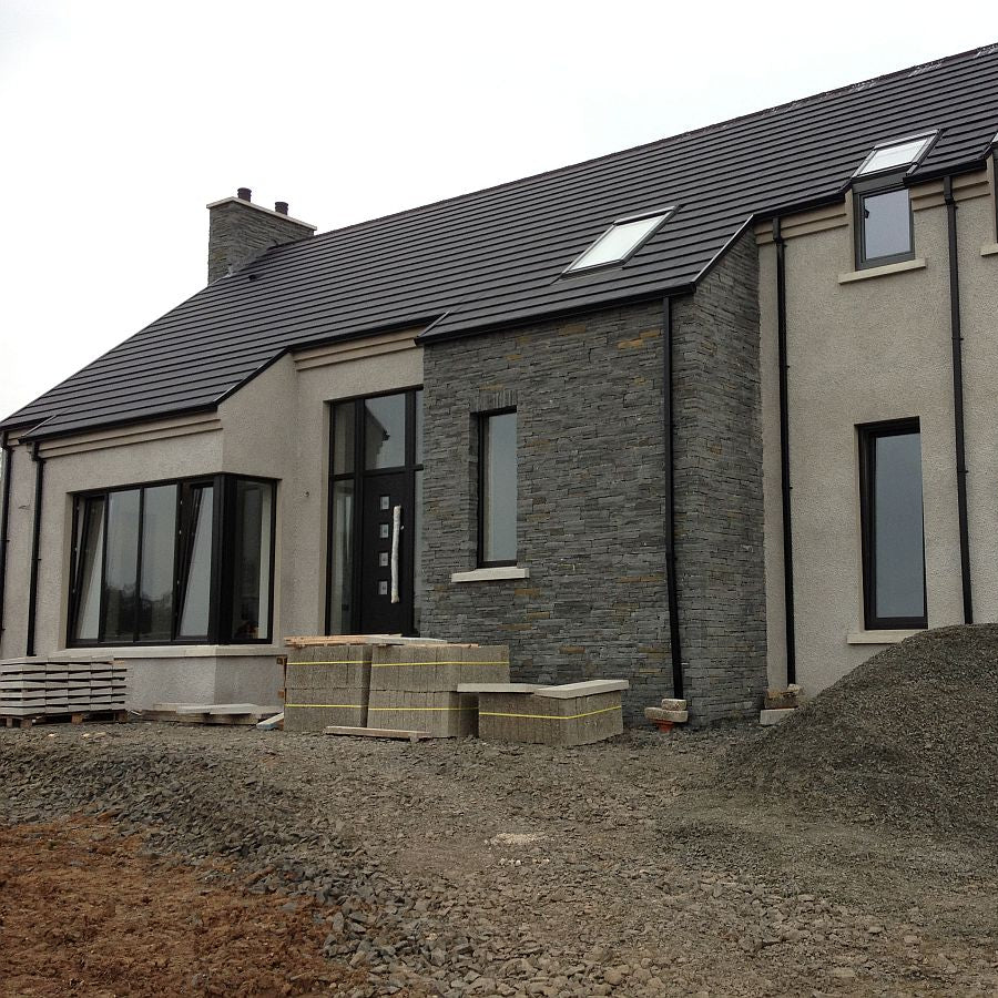 New build home with external feature wall in Liscannor Slate Machined walling stone.