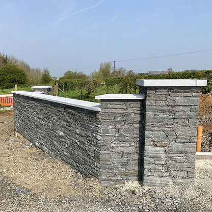 Boundary wall finished in Liscannor Slate machined building stone with silver granite wall and pillar capping.