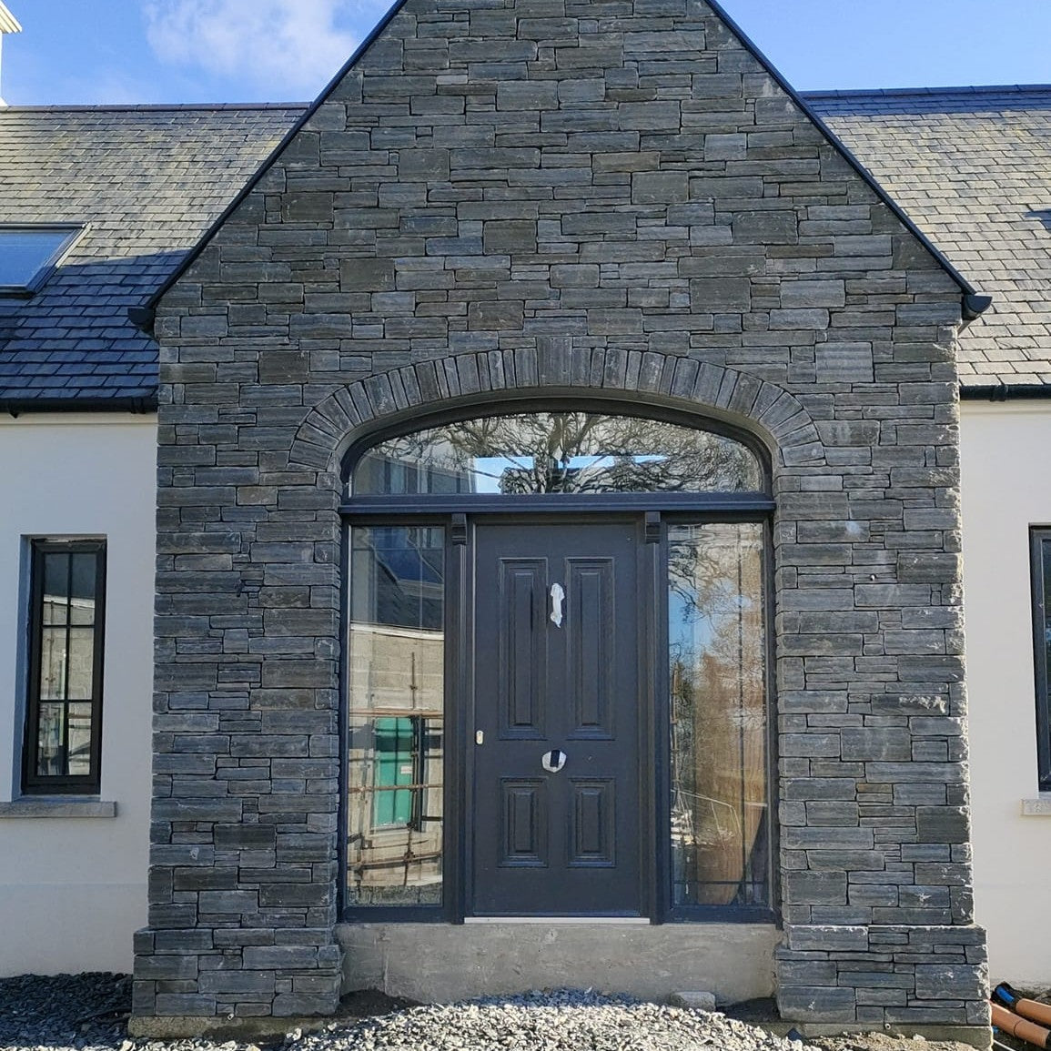 Large stone entrance featuring Liscannor Slate Stoneer Cladding. 