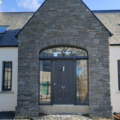 Large stone entrance featuring Liscannor Slate Stoneer Cladding. 