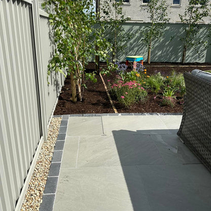 Planted garden with patio completed using Mercury Grey Jewel Range Porcelain Paving. 