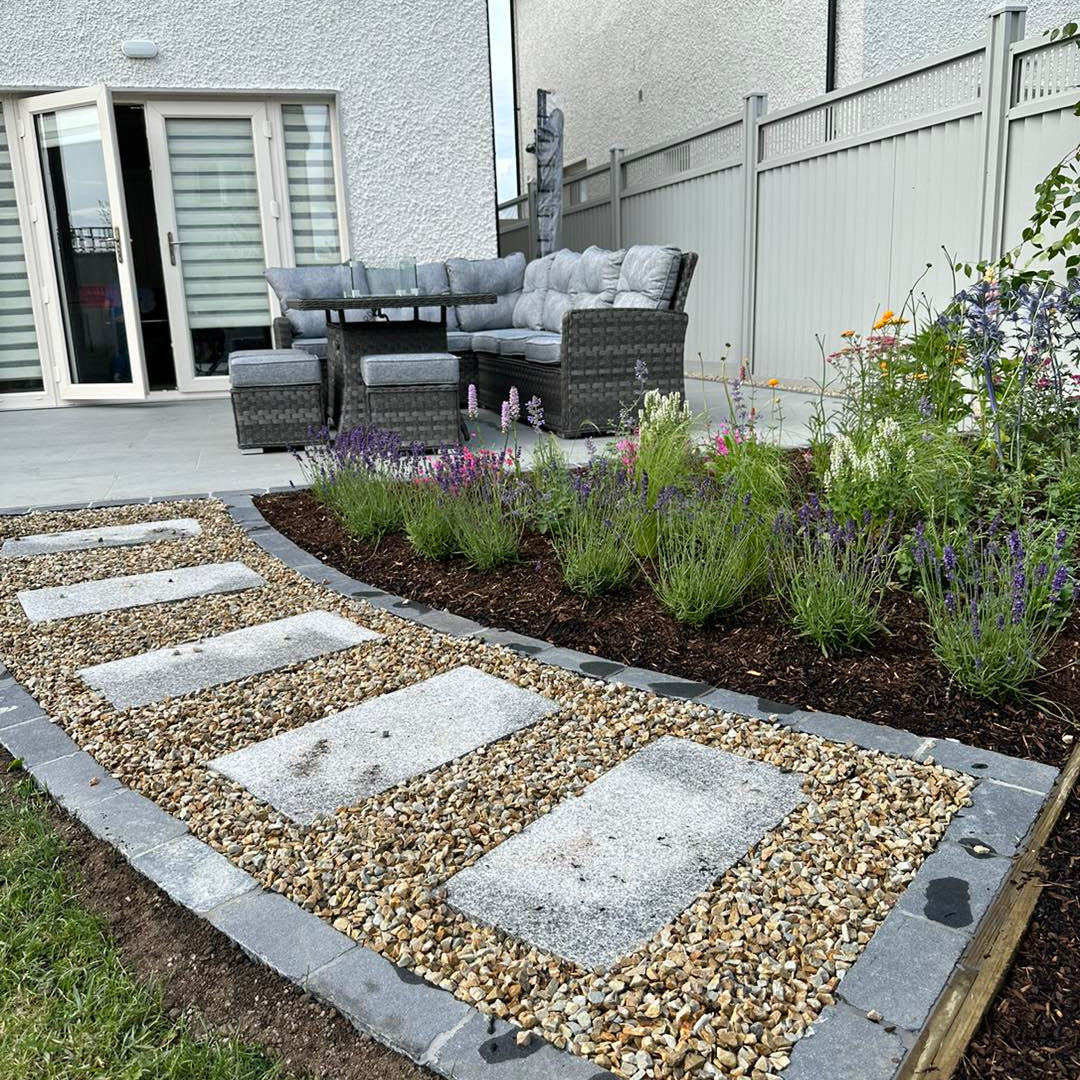 Pathway with stepping tiles leading to patio area finished using Mercury Grey Jewel Range Porcelain Paving. 
