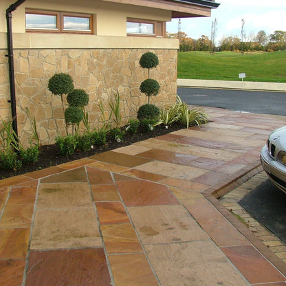 Golf club pathway completed with Modak Sandstone paving slabs in warm pink and orange tones.  