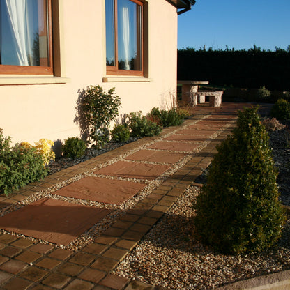Pathway with planting on either side completed using Modak Sandstone Paving Slabs. 