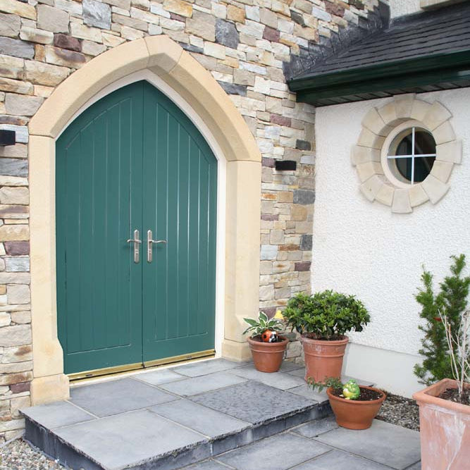 Stone entrance featuring a unique bespoke sandstone door surround. 