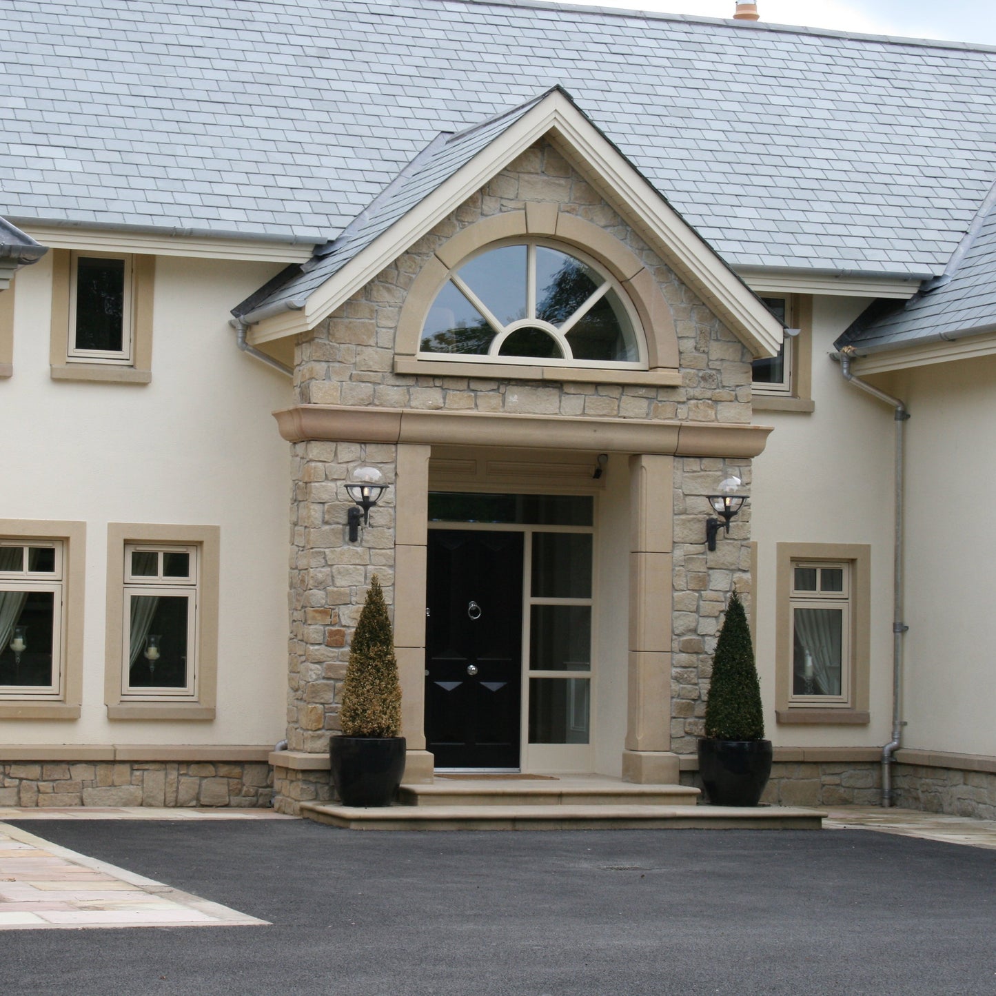Stone entrance with bespoke Sandstone Door and Window Surrounds. 