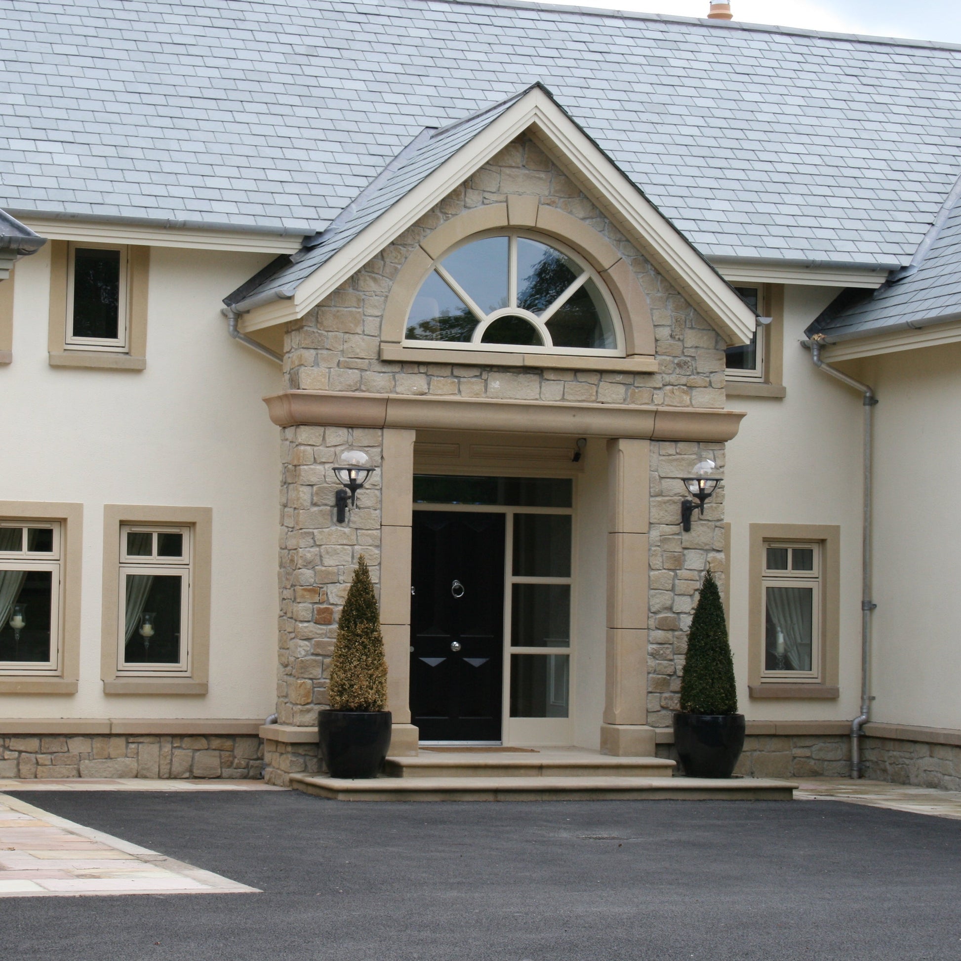 Stone entrance with bespoke Sandstone Door and Window Surrounds. 