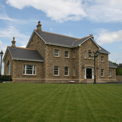 Two storey stone house completed in Mountcharles Sandstone Machined Rubble and architectural sandstone surrounds, quoins, steps and more. 